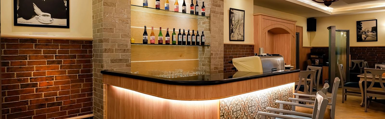An image of a wine bar in Bangalore featuring a bar counter and high chairs - Cross Roads Inn, Bengaluru