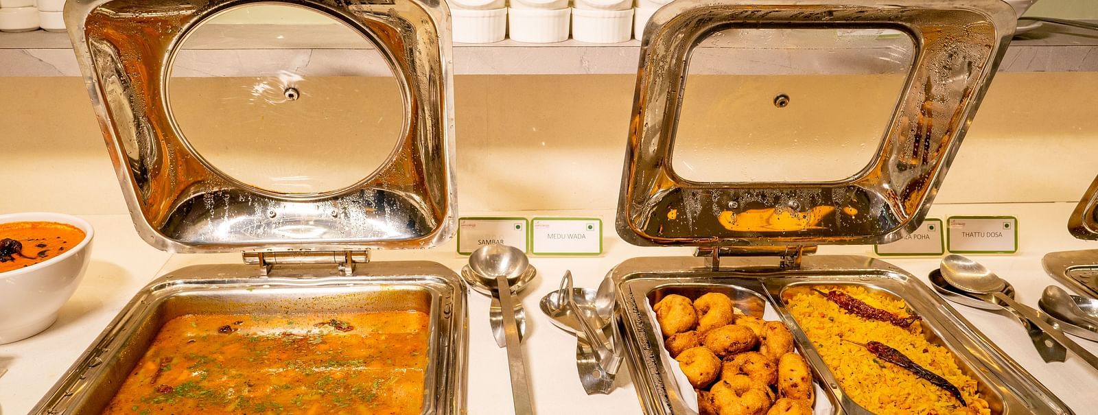 Chafing dishes with Indian cuisine on a buffet table - TGI Ameya Grand, Goa