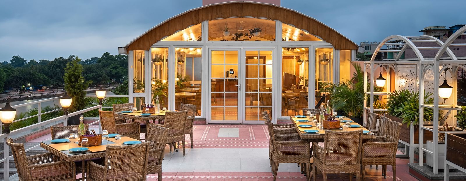 Restaurant Patio with the outdoor dining arrangement with tables and chairs  in clusters - Ganga Lahari, Haridwar