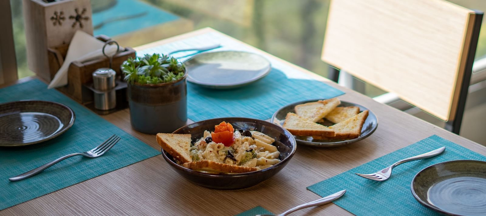 A dish placed on a table with cutlery arranged beside it at BluSalzz Escapade Resort, Lansdowne