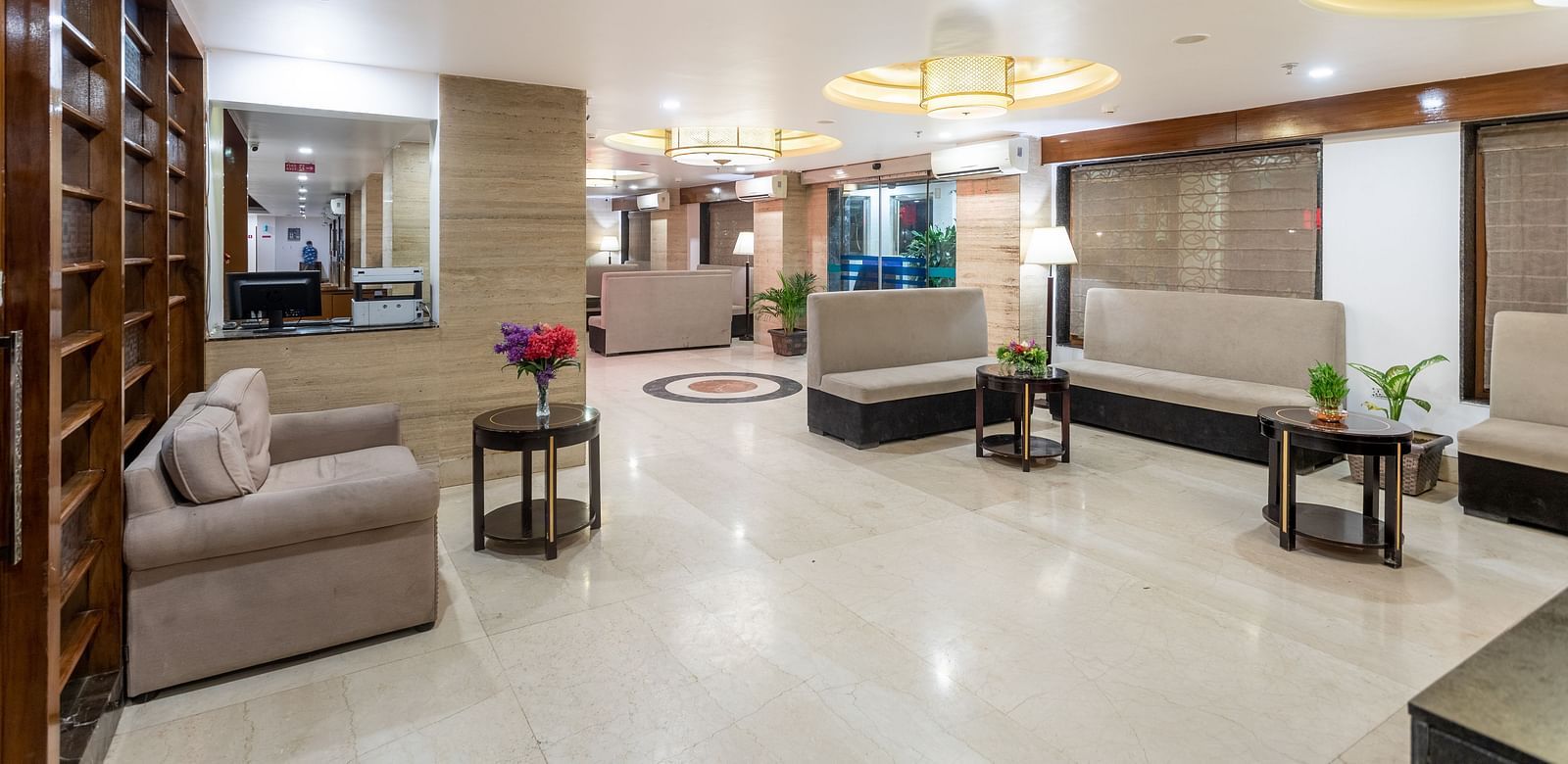 Spacious and well-lit lobby at Diamond Palace Lords Plaza with comfortable seating arrangements and decorative lighting.