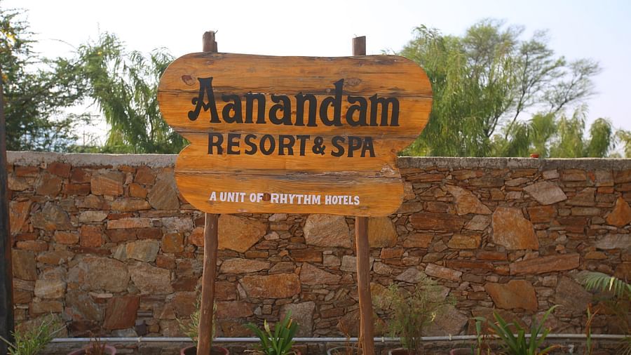 Hotel name board displayed at the entrance of Aanandam Resort & Spa