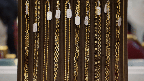 Display of gold necklaces hanging in a jewellery shop.
