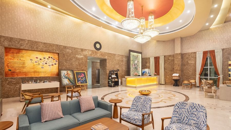 A circular seating area with a marble floor and a chandelier.