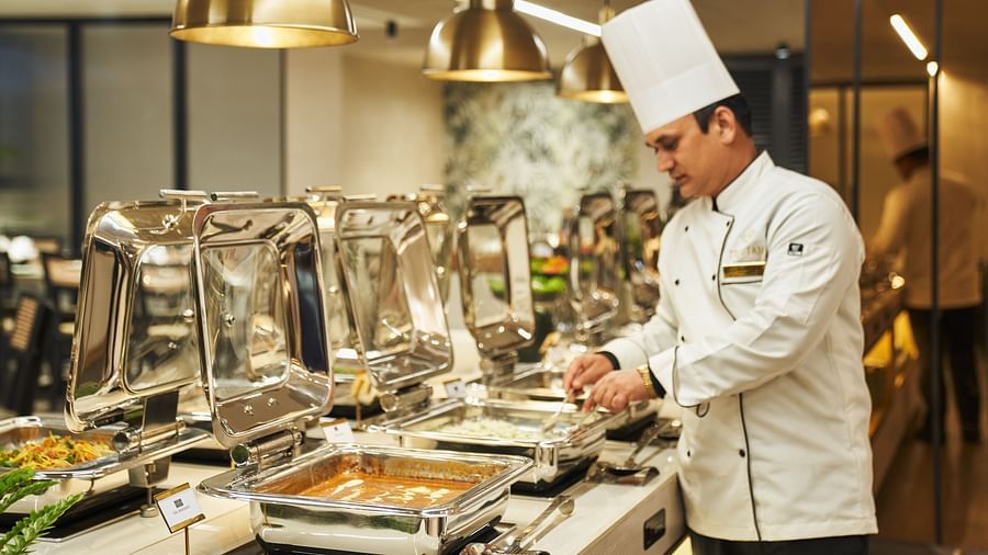 a chef adding finishing touches on a dish at Mishri, the restaurant at Triptam Hotel, Vrindavan