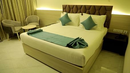 Luxurious king-size bedroom at Town Square Suites with modern decor and ambient lighting