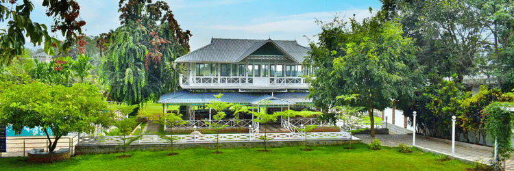 picture of a Huge building with a lawn in the front captured in  the day time