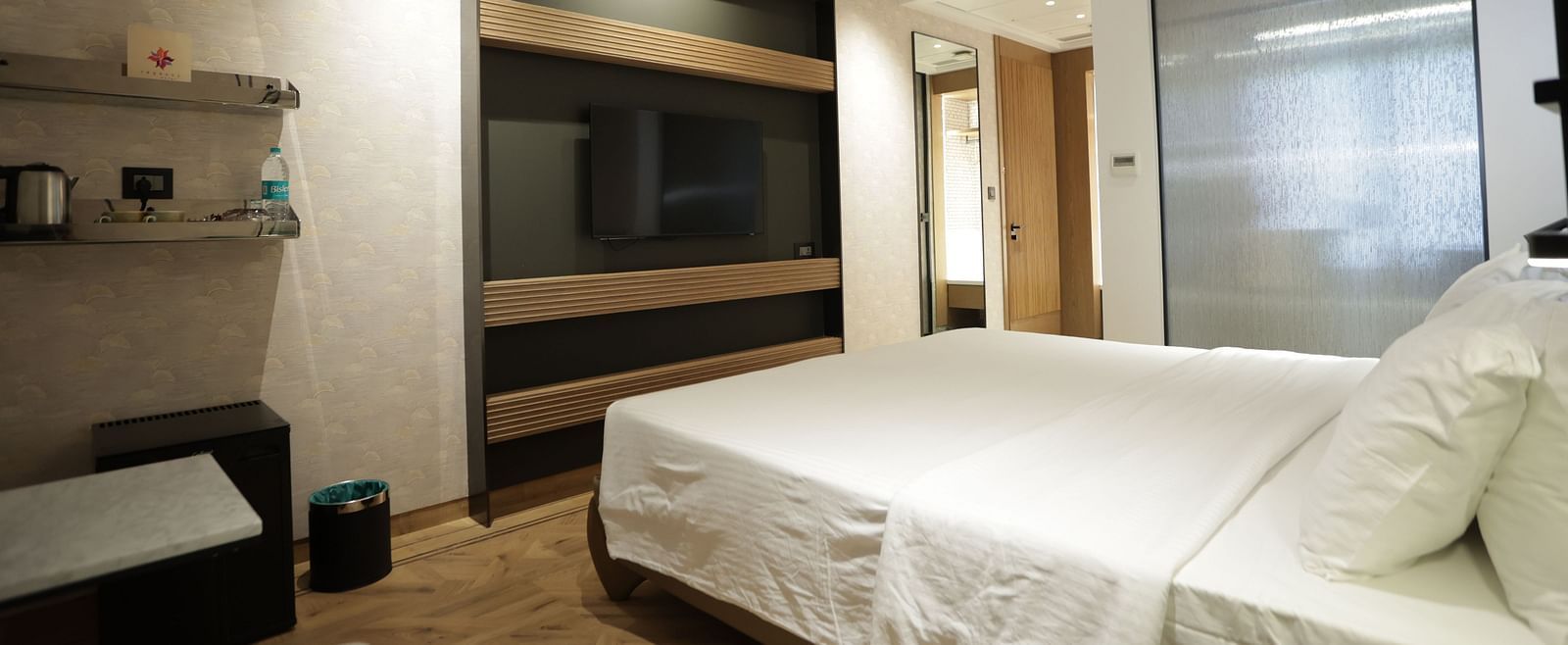 Premium accommodation at Regency Hotel, Mumbai featuring comfortable bedding, entertainment system, modern amenities and sophisticated interior design for guests.