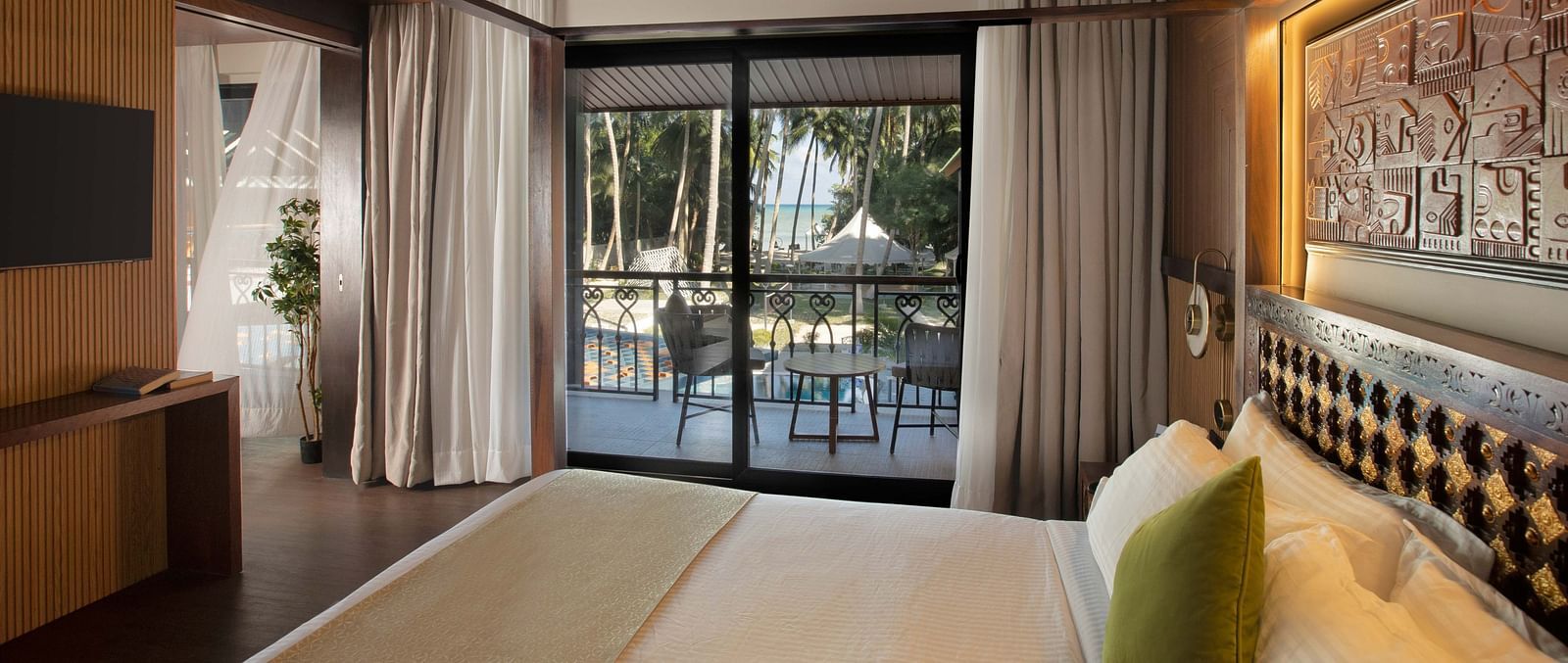 Image of the doorway to the balcony taken from the plush bed in Coral Teal Suite at Coral Reef Resort and Spa in Havelock