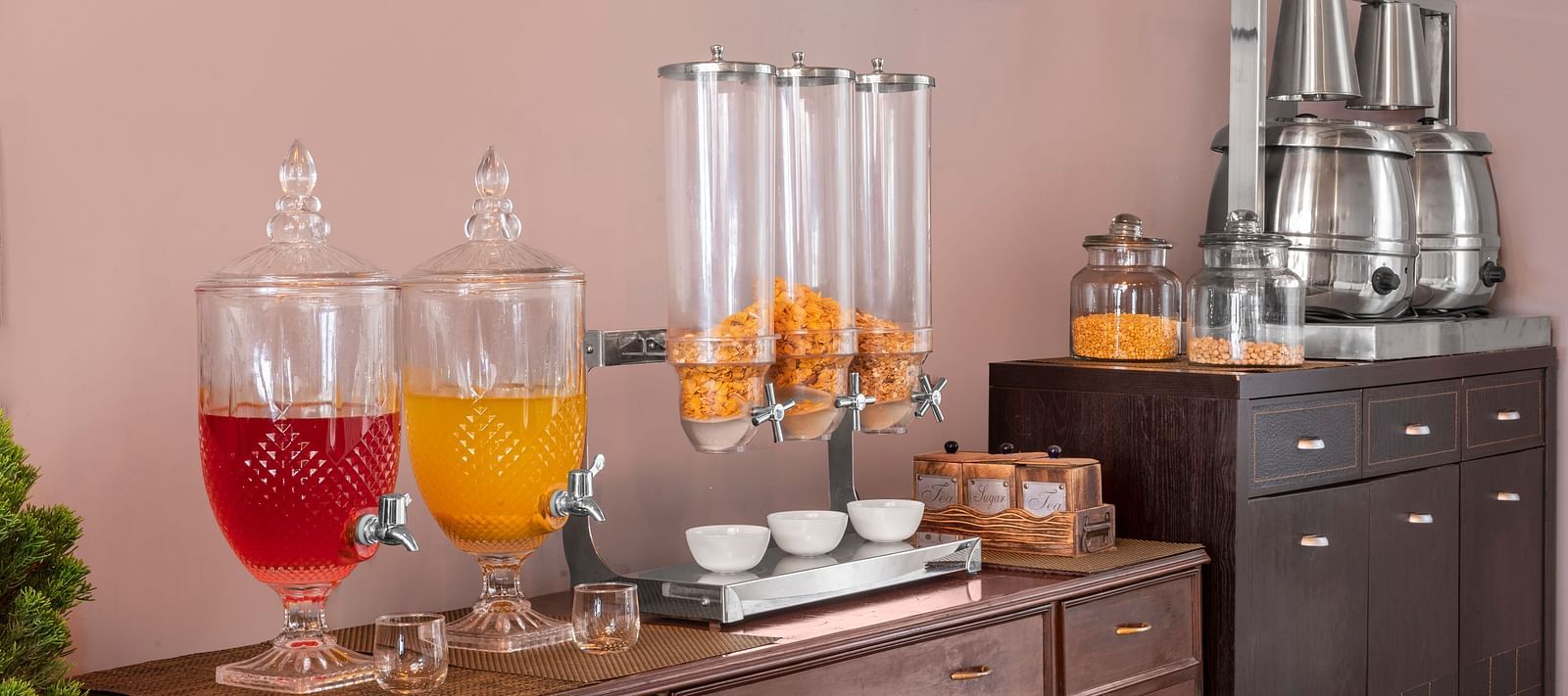 Self-serve breakfast counter with juice dispensers, cereals, and tea set-up, at BluSalzz Collection - Suvaasa Resort, Ramgarh.