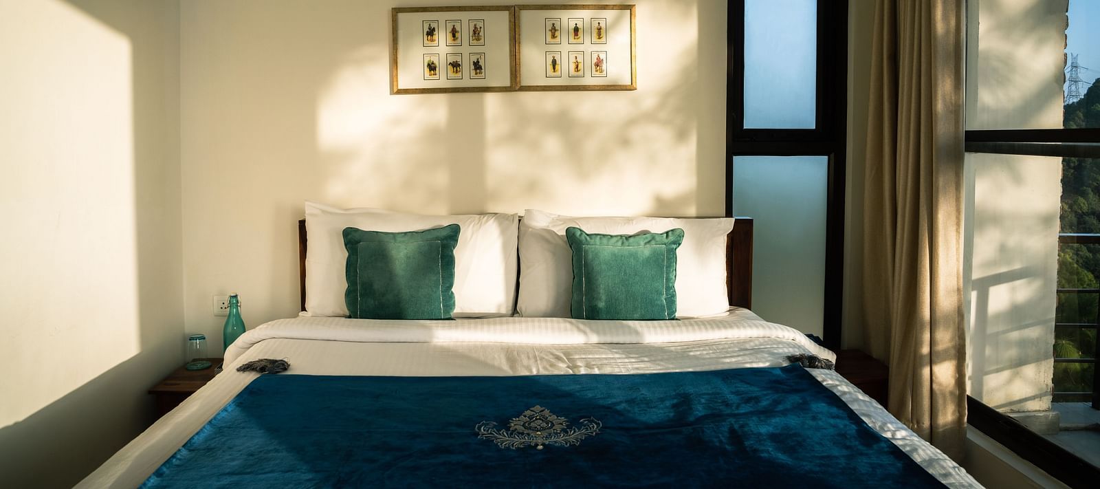 A bedroom with sunlight streaming through the windows at BluSalzz Escapade Resort, Lansdowne.