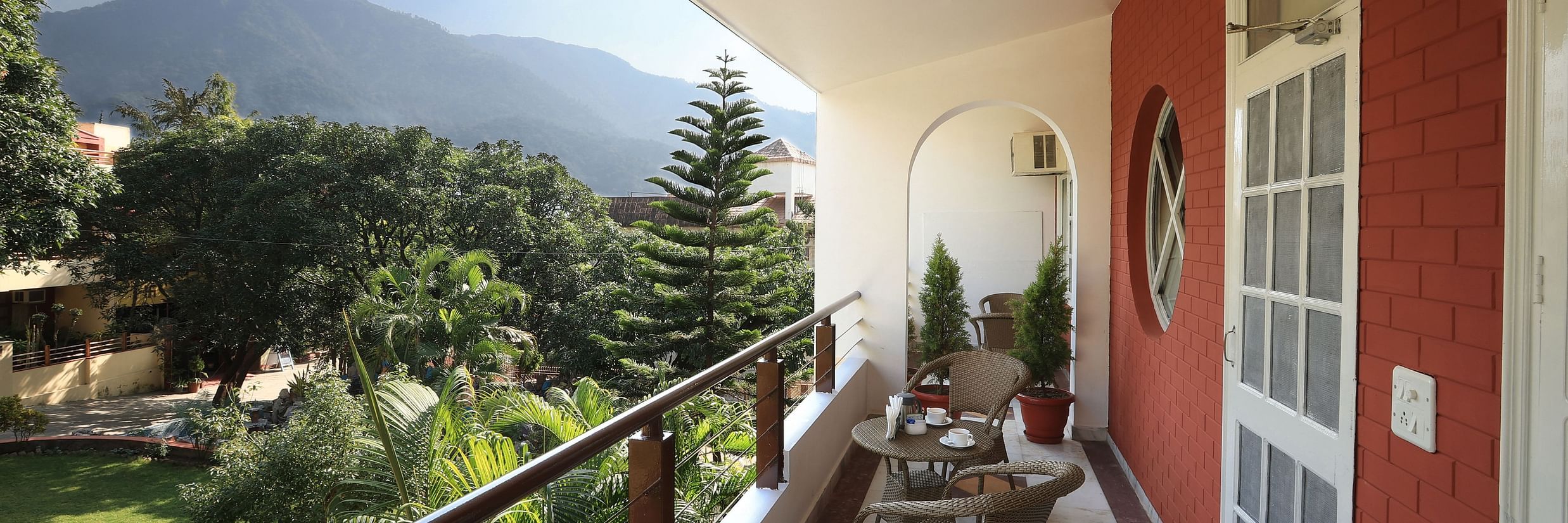 Super Deluxe Room balcony offers a view of the surrounding greenery - Lamrin Boutique Cottages Rishikesh