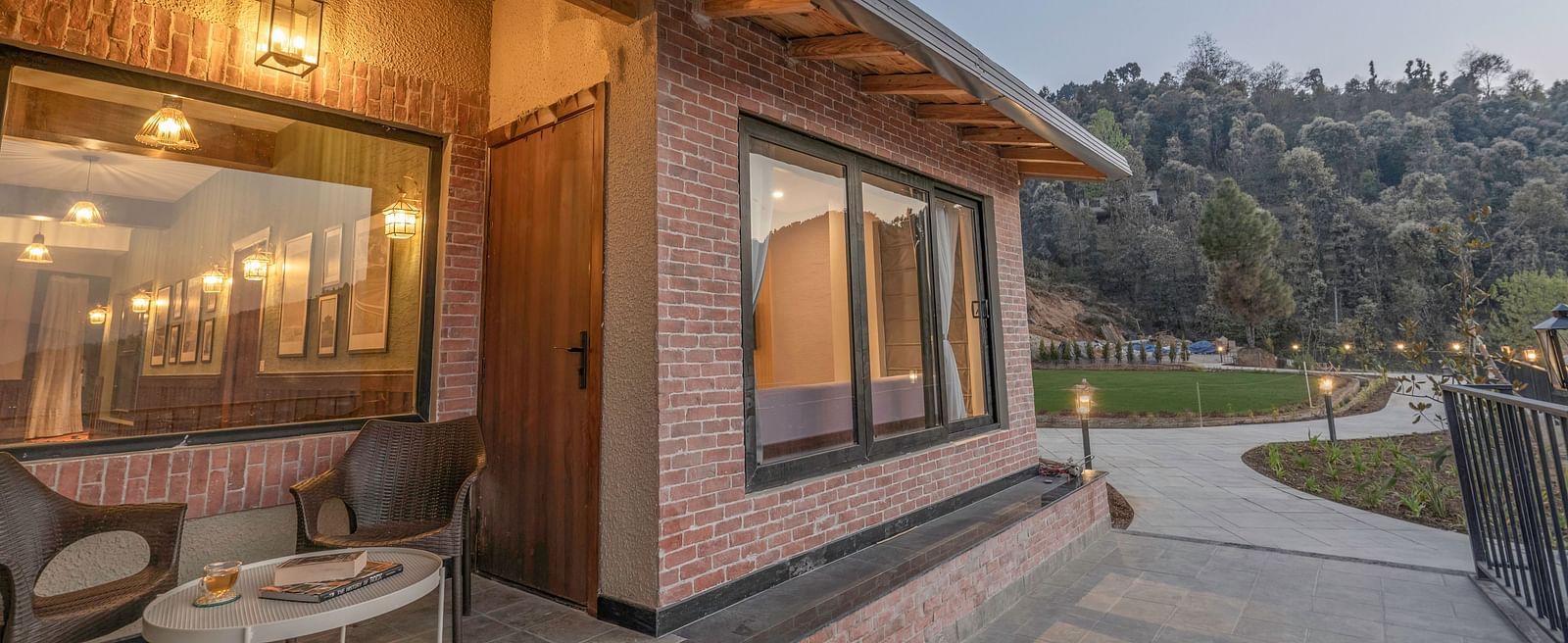 Exterior view of a modern building with outdoor seating at The Chamomile Estate.