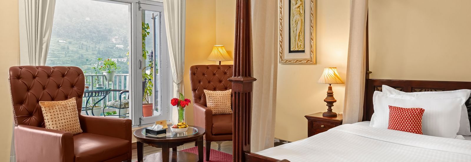 Elegant bedroom with a cosy seating area and a mountain-view balcony at BluSalzz Collection - Suvaasa Resort, Ramgarh.