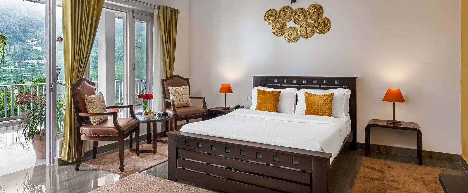 Spacious bedroom with large bed, seating area, and balcony access, at BluSalzz Collection - Suvaasa Resort, Ramgarh.