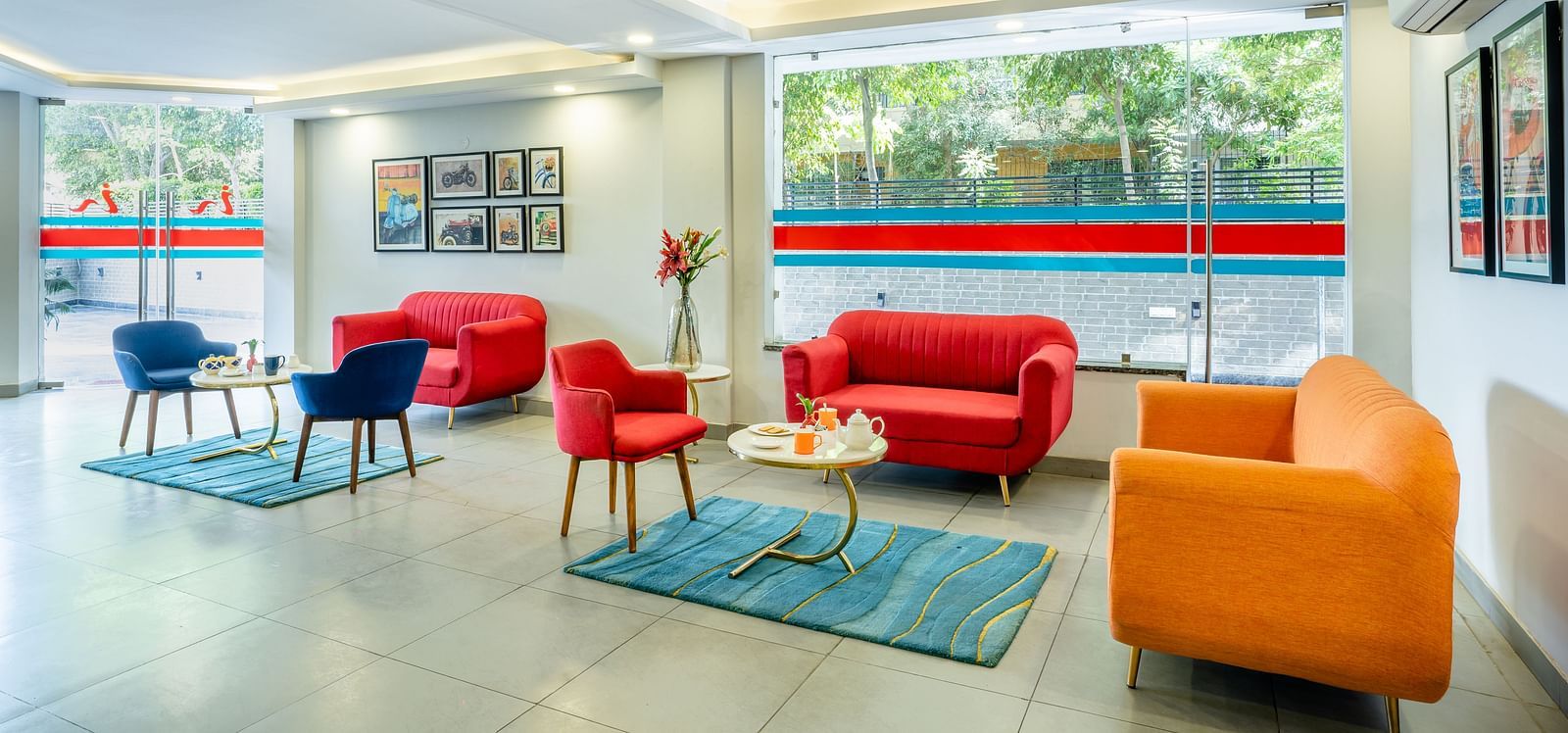 An image of a lobby with two sitting arrangements | Inde Hotel Golf Course Extension