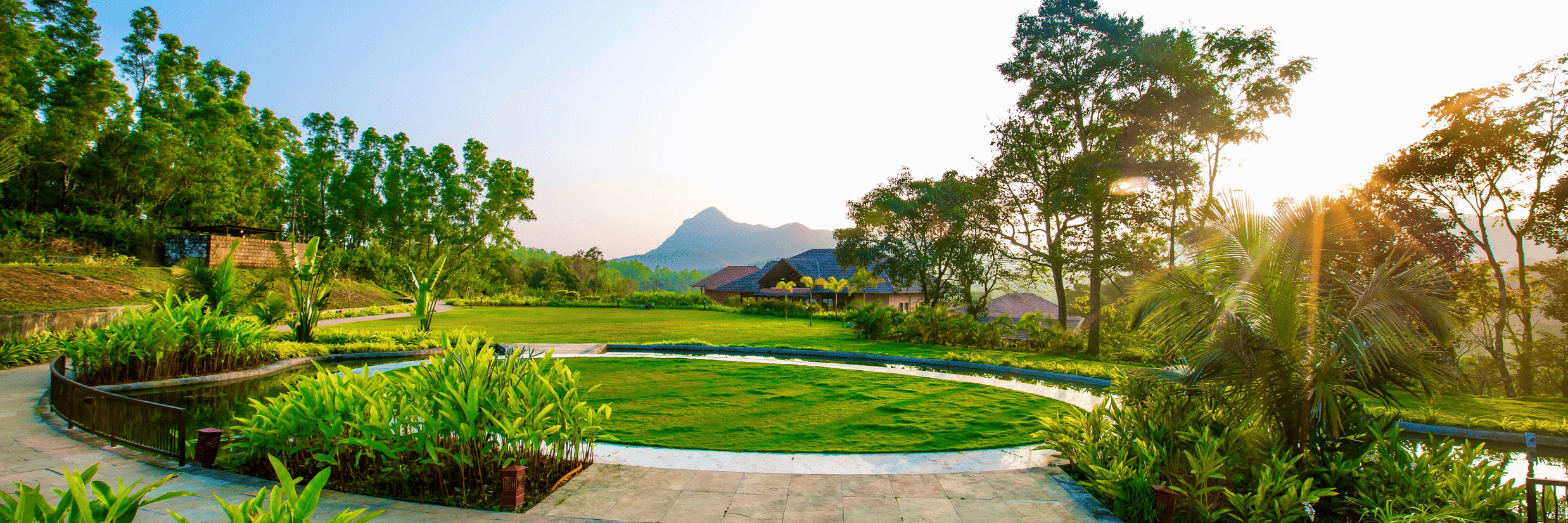 Machaan Plantation Resort grass lawns with mountain view