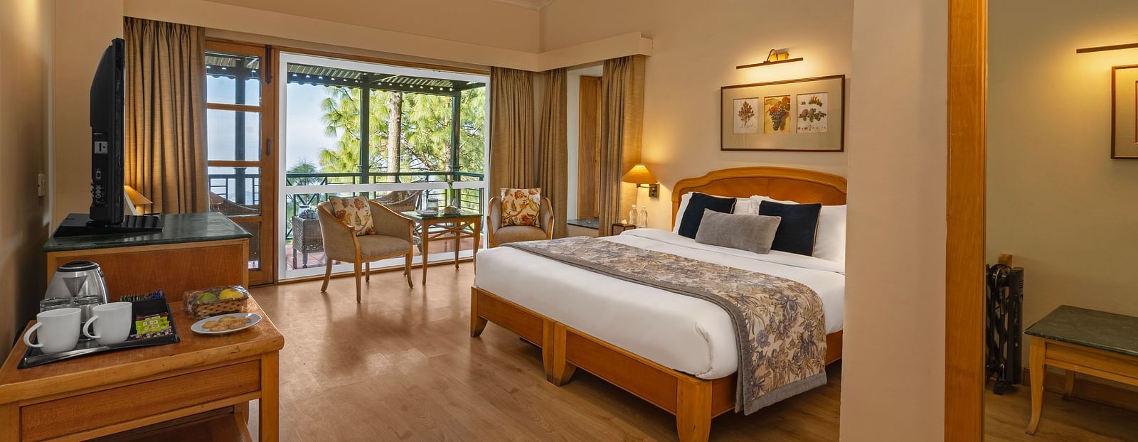 Superior cottage valley view bedroom featuring tables set with tea supplies, including sugar and tea bags, and a balcony with chairs arranged for seating -  Baikunth resort, kasauli 