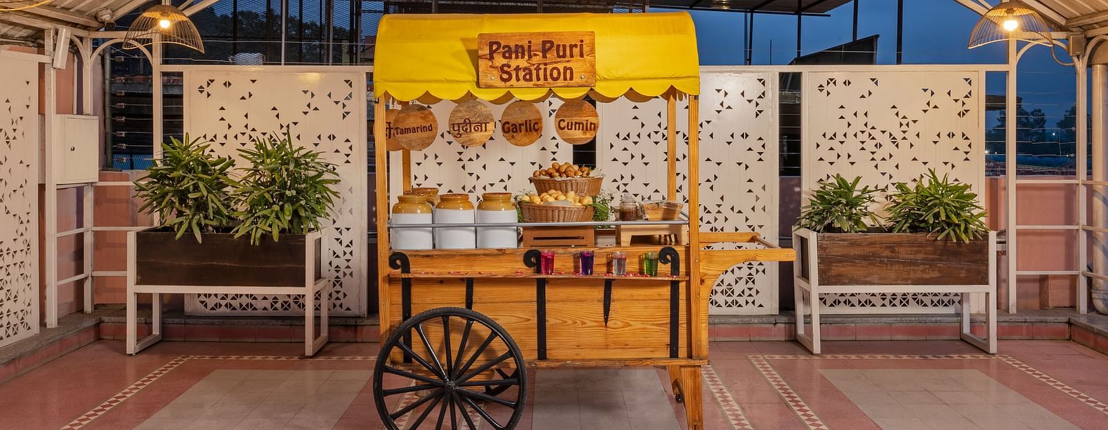 A colorful food cart serving freshly prepared Indian street food.