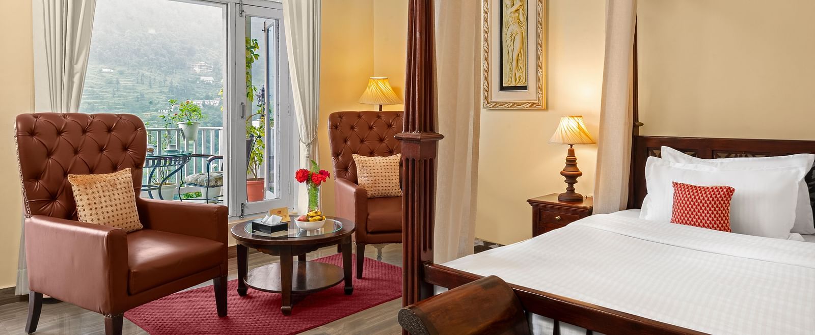 Elegant bedroom with a cosy seating area and a mountain-view balcony at BluSalzz Collection - Suvaasa Resort, Ramgarh.