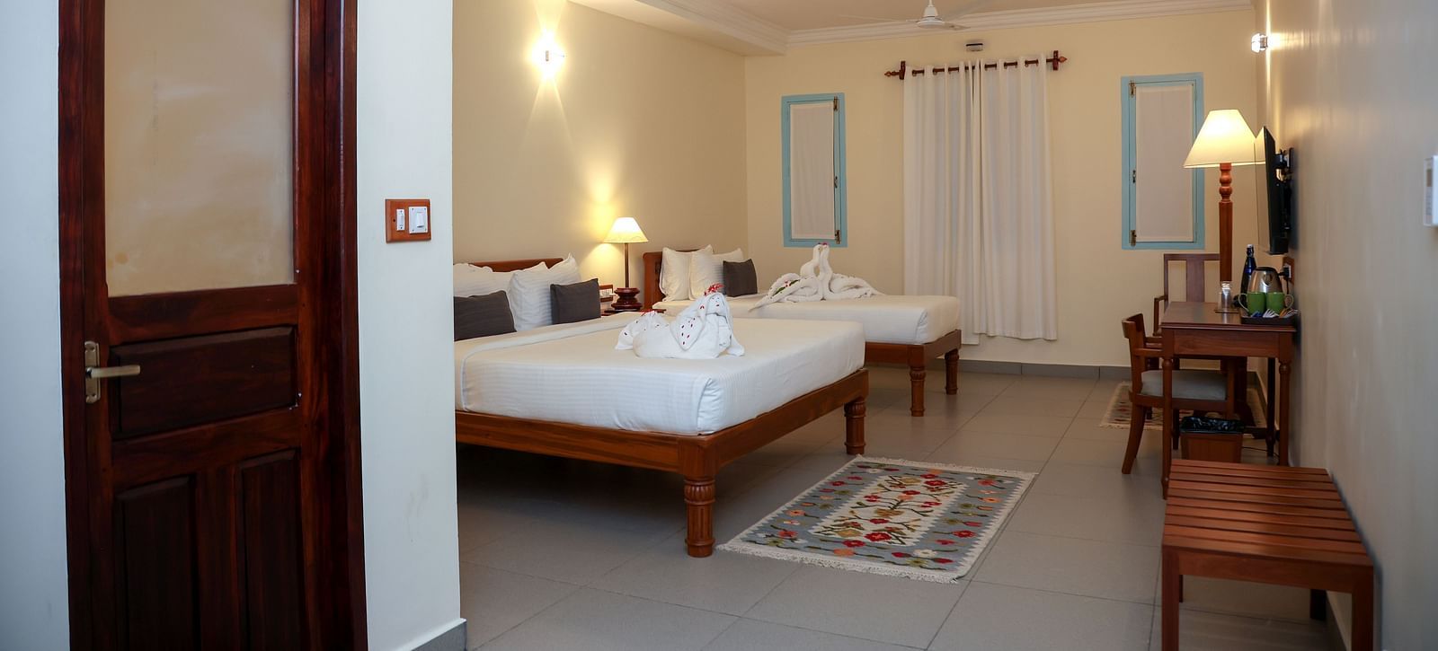 A master suite bedroom with two beds, tables and other furnitures  | Mango Hill La Serene, Pondicherry