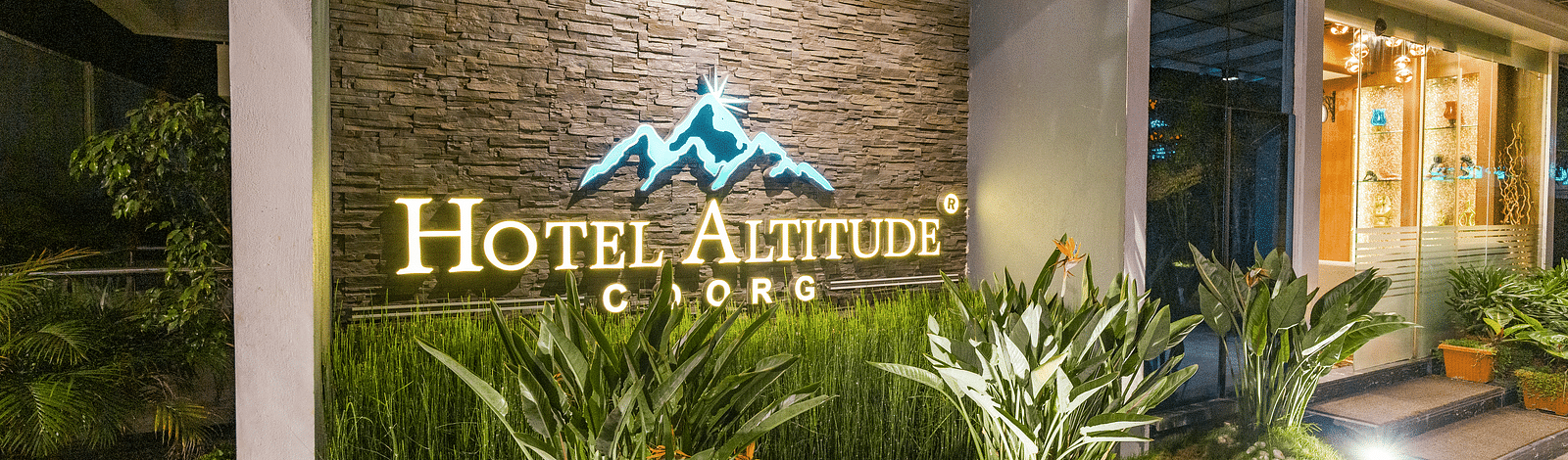 A wall with Hotel Altitude written on it at Hotel Altitude, Madikeri.