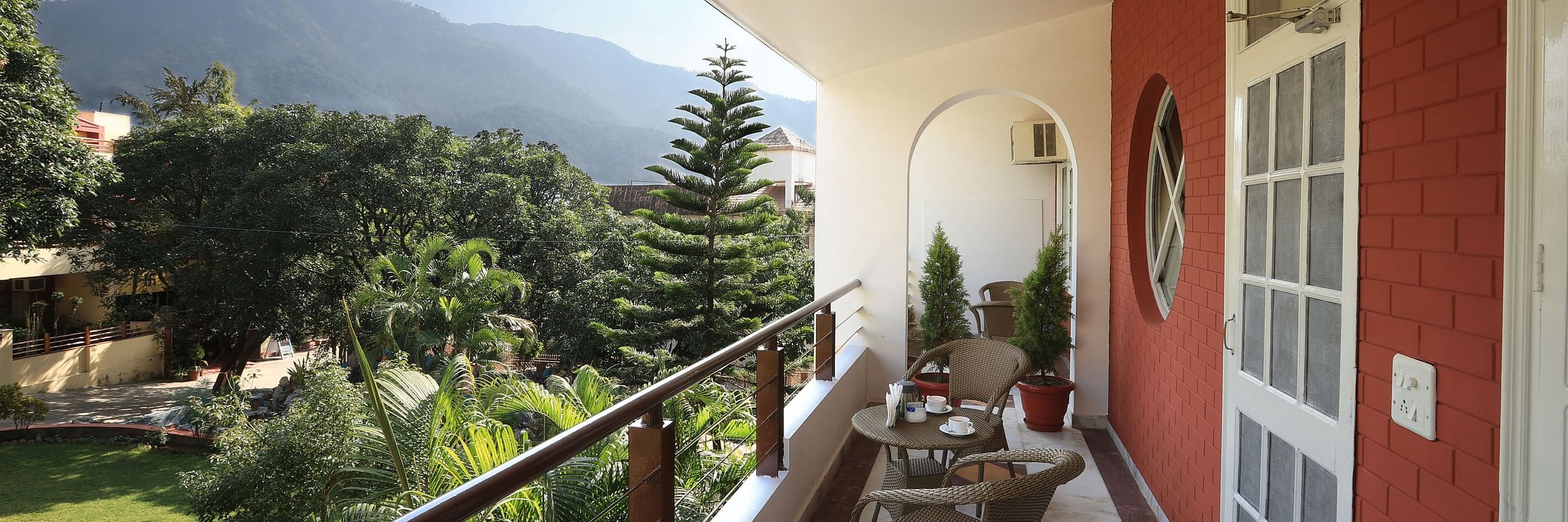 Super Deluxe Room balcony offers a view of the surrounding greenery - Lamrin Boutique Cottages Rishikesh