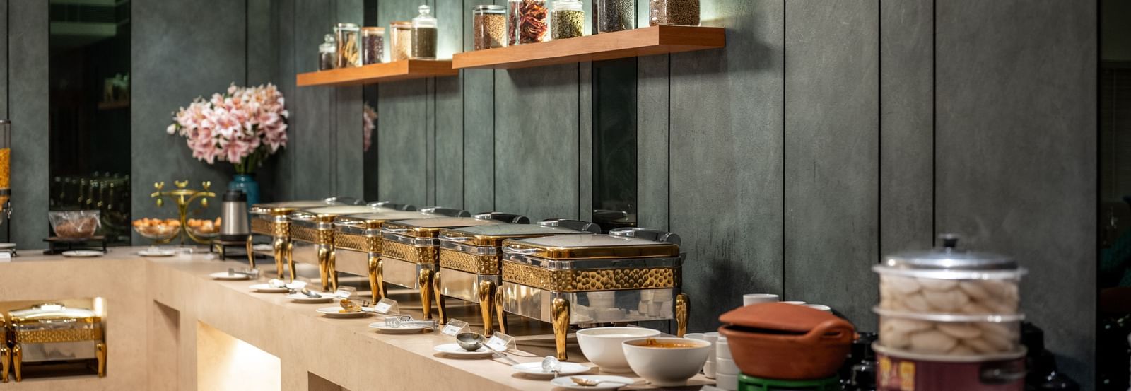 Buffet spread with assorted jars and traditional pots at Hotel Royal Regency Chennai