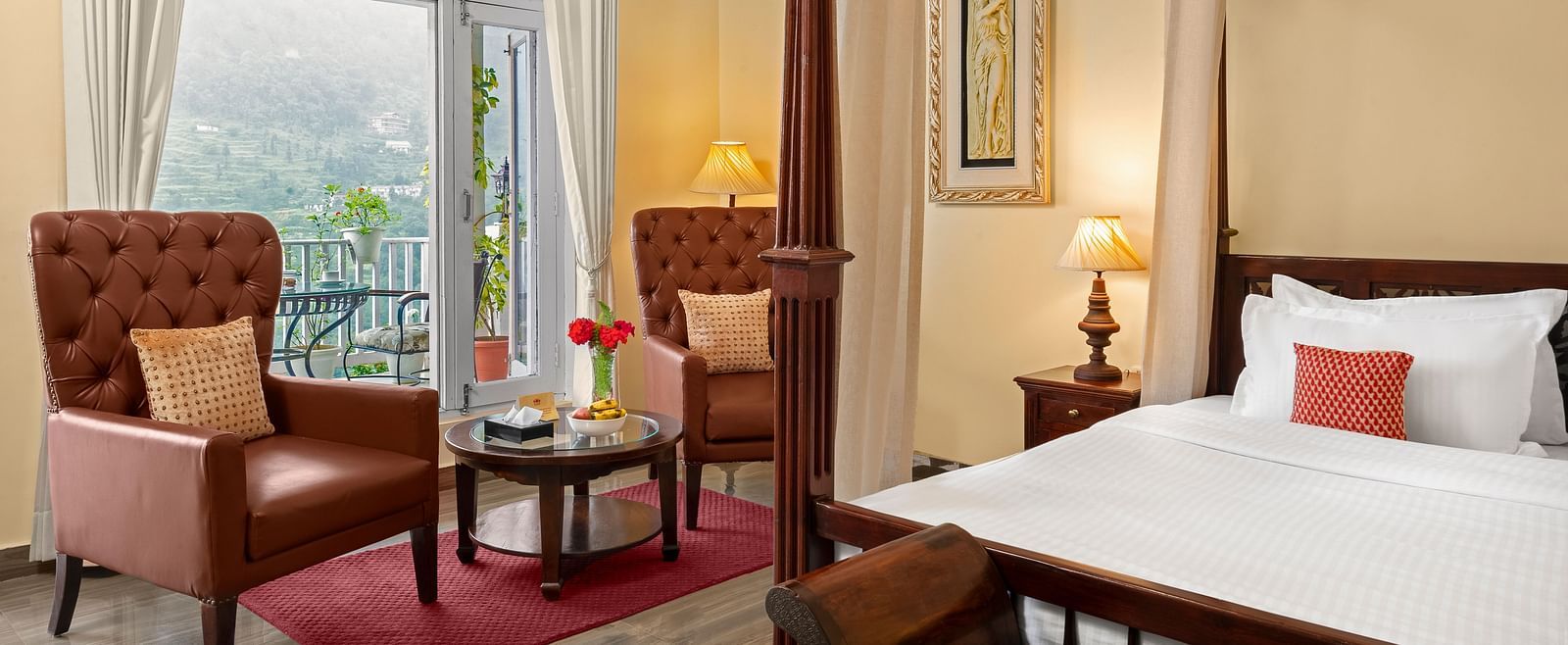 Elegant bedroom with a cosy seating area and a mountain-view balcony at BluSalzz Collection - Suvaasa Resort, Ramgarh.