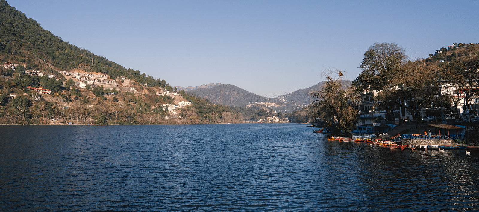 BluSalzz Villas - The Green Roof, Bhimtal, offers a breathtaking lake view surrounded by majestic mountains and a pristine, clear sky.