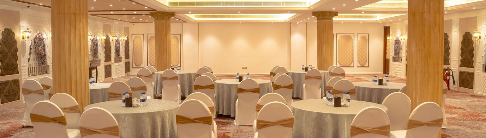 Lavish event space with round tables and grand columns - Kaldan Samudra Palace
