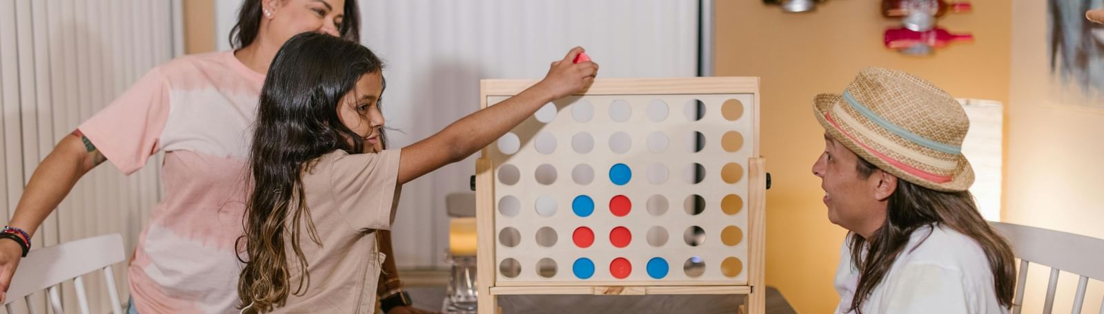 A family enjoying a game of Connect Four