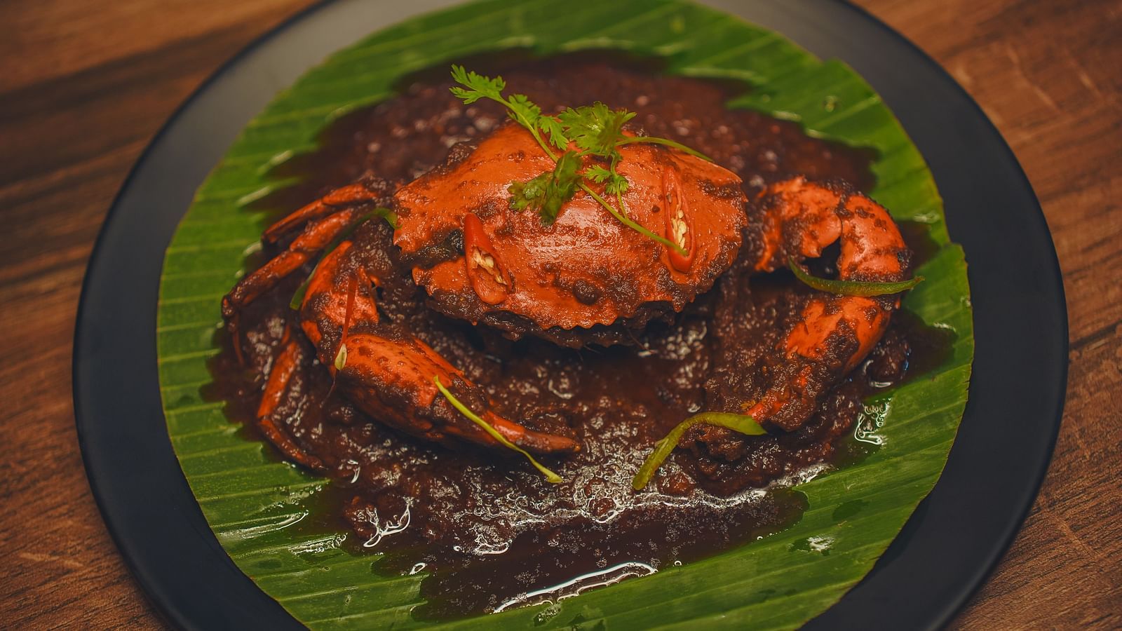 image of dish featuring whole crab smeared with spices - Dip Holidays, Birbhum