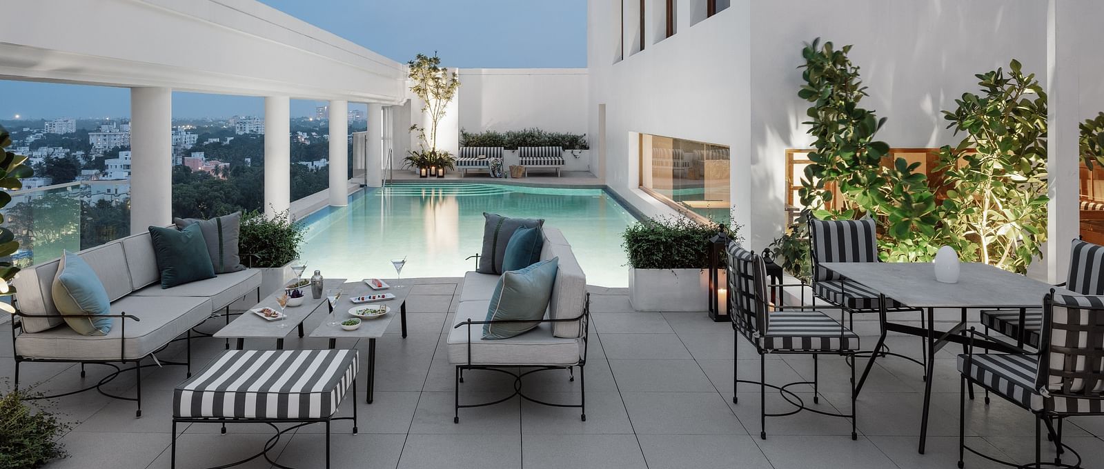 Image of a Swimming pool  with chairs and tables on the side at The Raintree St.. Mary s Road