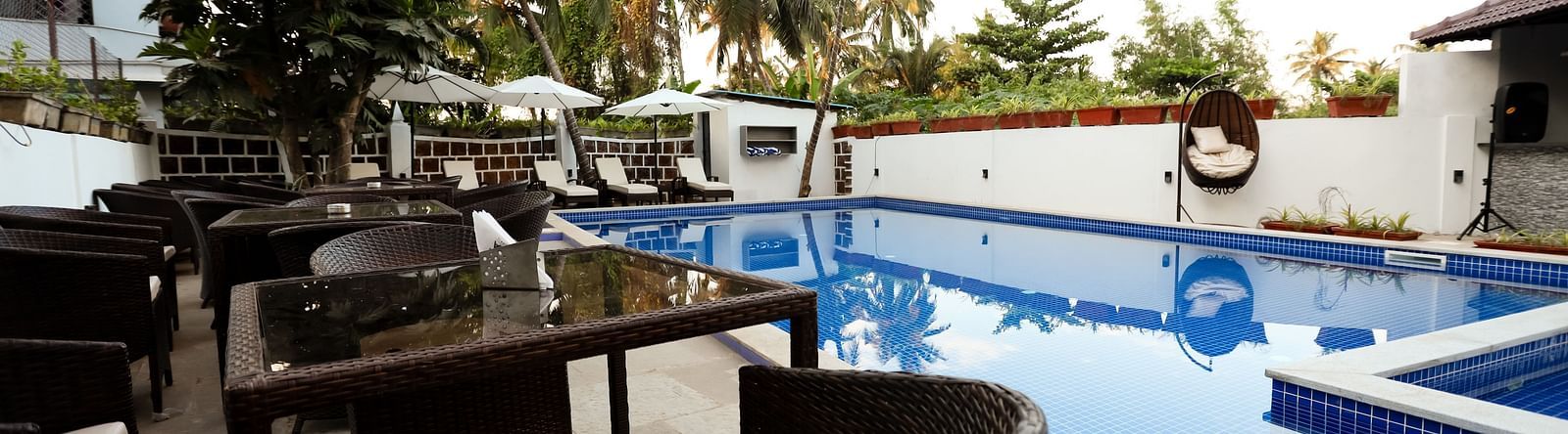 Image of a seating area beside a swimming pool at Calux Grand Baga.
