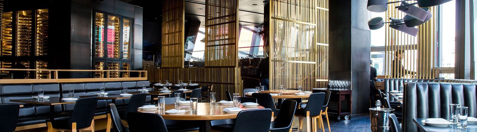 Seating arrangements inside a restaurant with the sun light shining through the windows