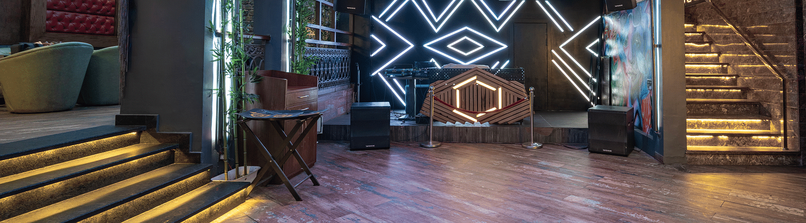 A dancing floor at Hotel Moti Palace featuring a DJ setup with colorful lighting, creating an energetic atmosphere for guests