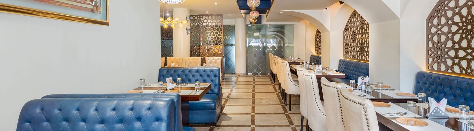 A n aisl view of the restaurant along with comfy sofa and table  Hotel Moti palace .