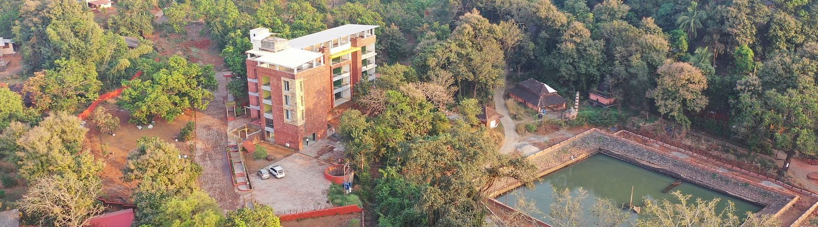 An aerial view of the resort with the facade of the building surrounded by trees and plants at SeaFort Beach Resort