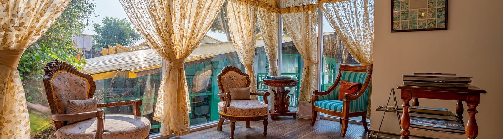 An open area with chairs and curtains at Te Aroha By Shervani, Mukteshwar