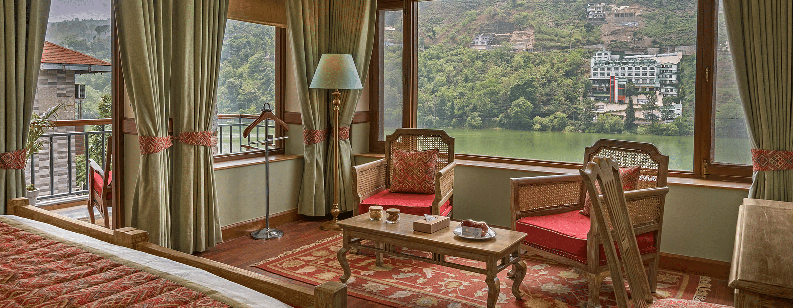 A cozy and royal sitting area in the Superior Lake Facing Rooms at Fishermen's Lodge, Bhimtal, offering stunning views of the lake.