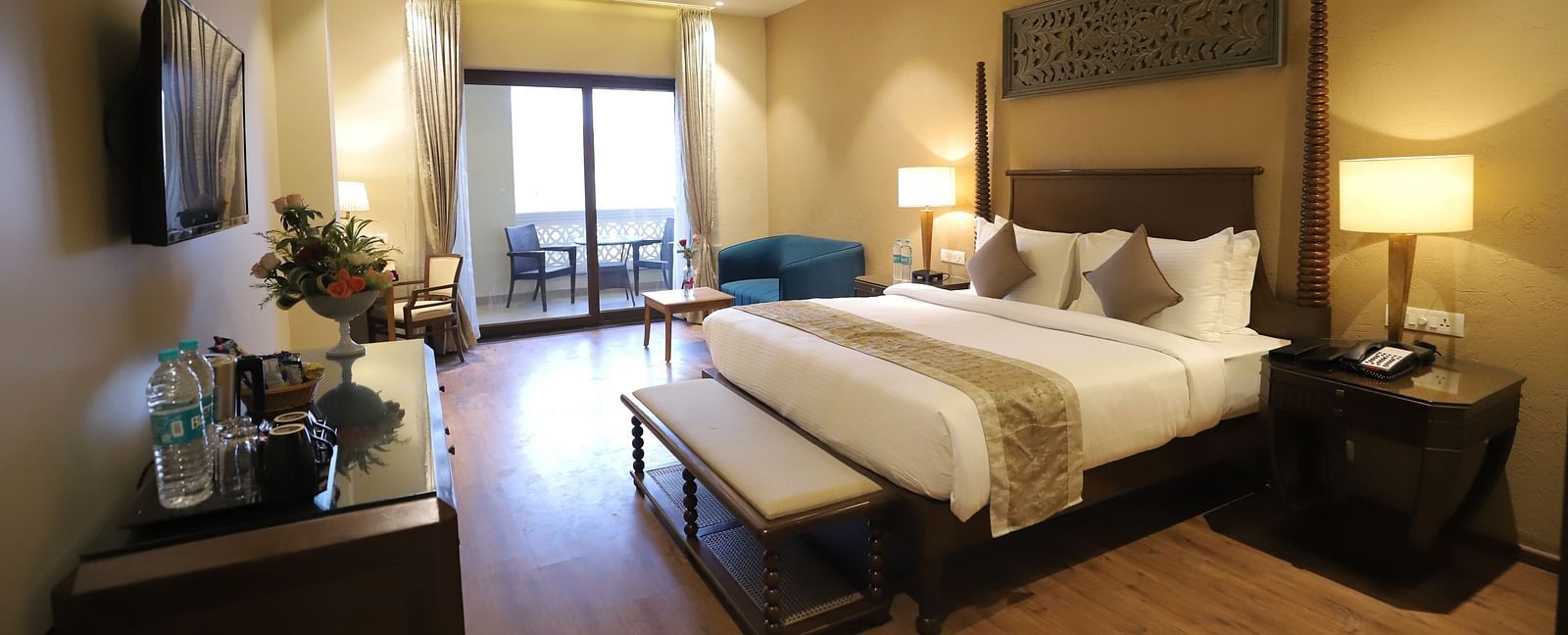 Premium room with a king size bed placed in front of a TV at Essentia Luxury Resort & Spa, Udaipur.