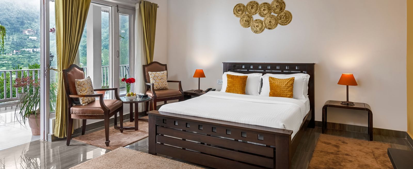 Spacious bedroom with large bed, seating area, and balcony access, at BluSalzz Collection - Suvaasa Resort, Ramgarh.