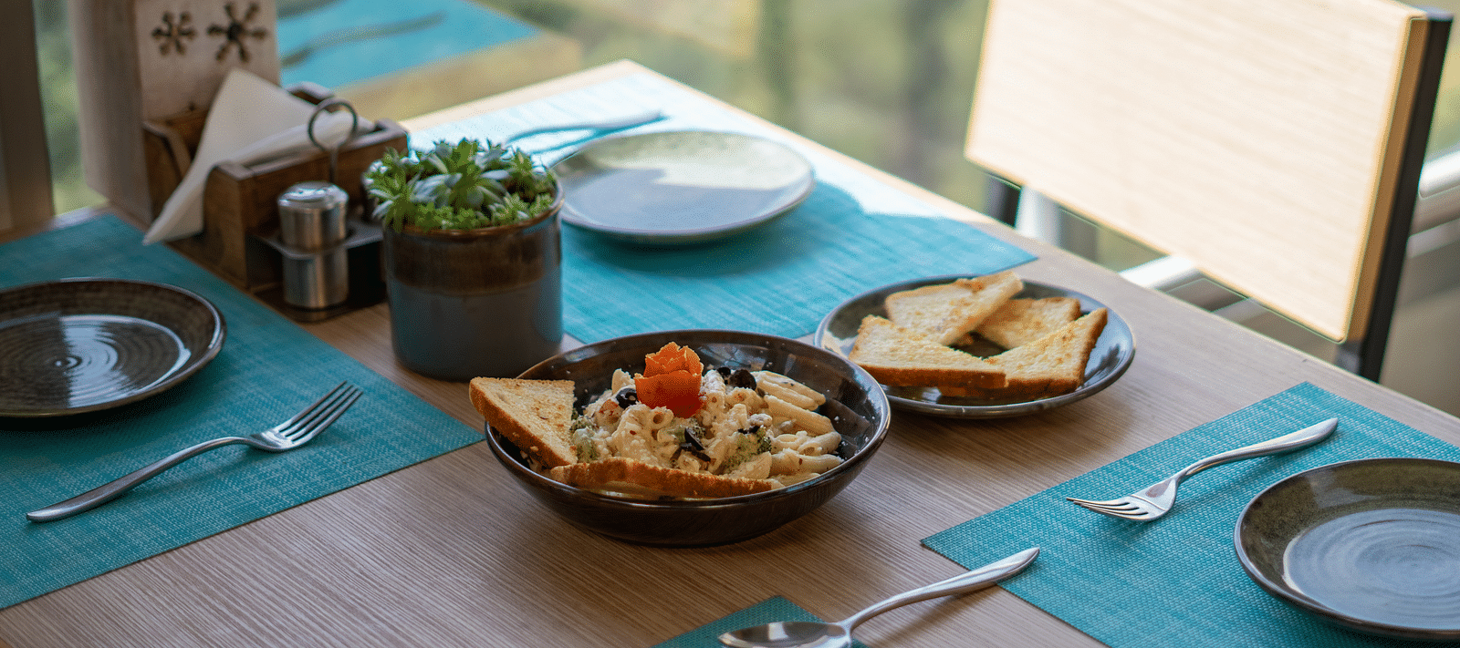 A dish placed on a table with cutlery arranged beside it at BluSalzz Escapade Resort, Lansdowne