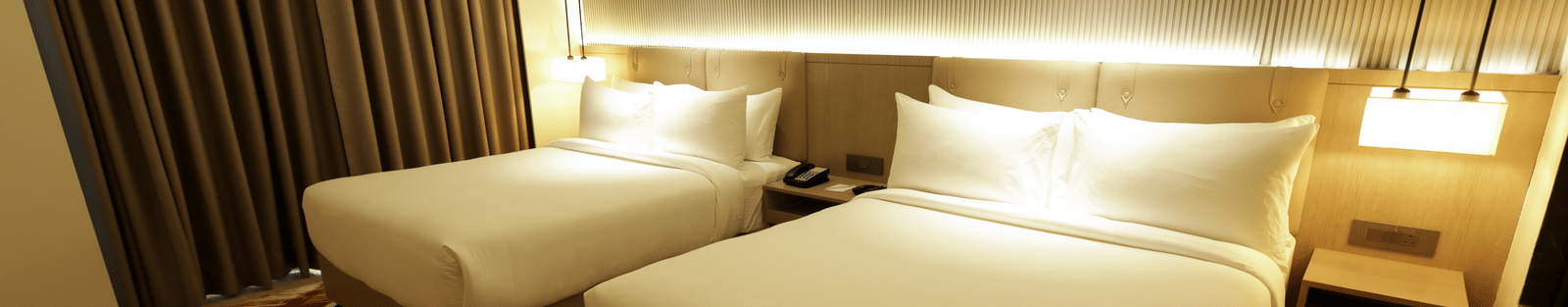 Bedroom with ambient lighting and artwork at Ramada by Wyndham Sonipat Murthal