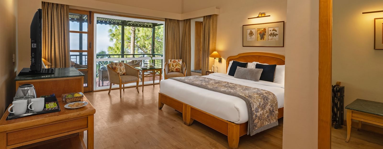 Superior cottage valley view bedroom featuring tables set with tea supplies, including sugar and tea bags, and a balcony with chairs arranged for seating -  Baikunth resort, kasauli 