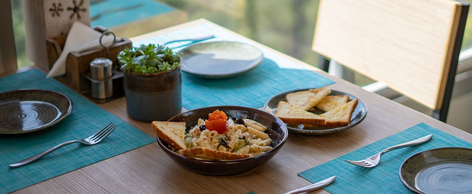 A dish placed on a table with cutlery arranged beside it at BluSalzz Escapade Resort, Lansdowne