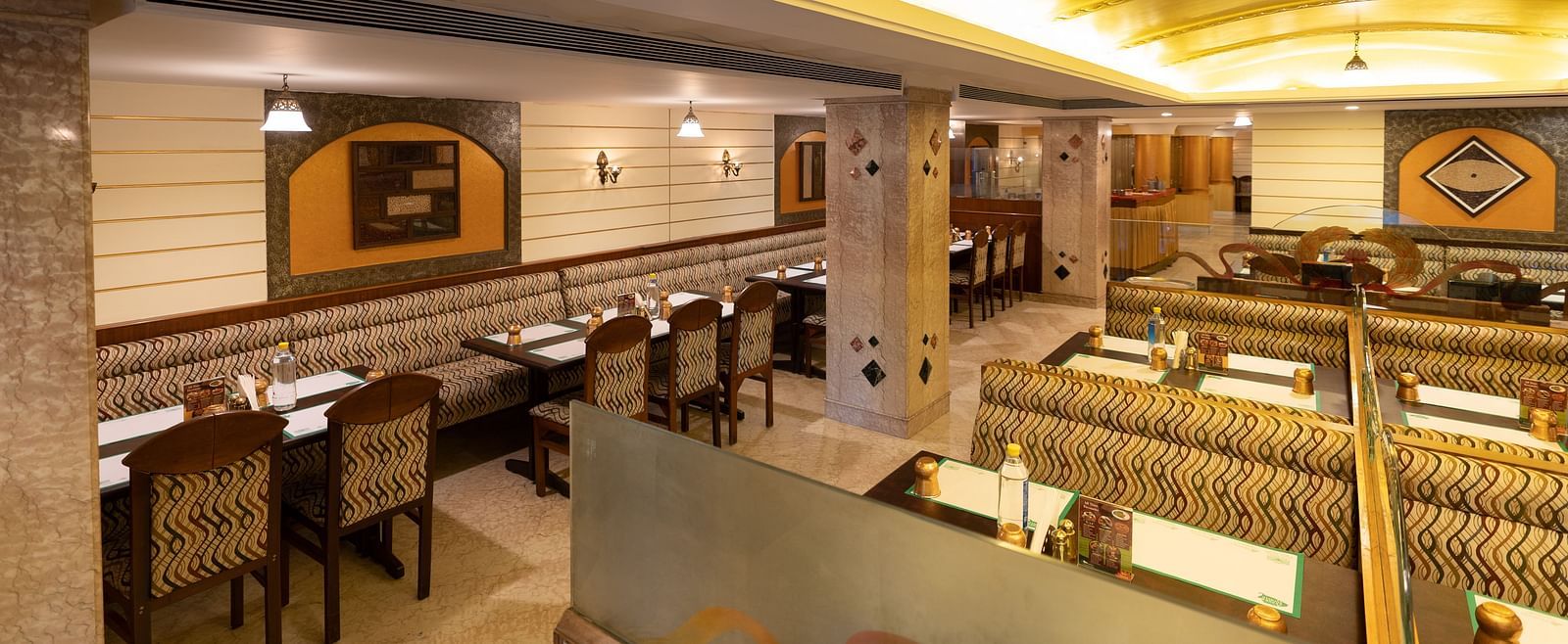 An image of a seating arrangement in restaurant at Hotel Pai Comforts, JP Nagar