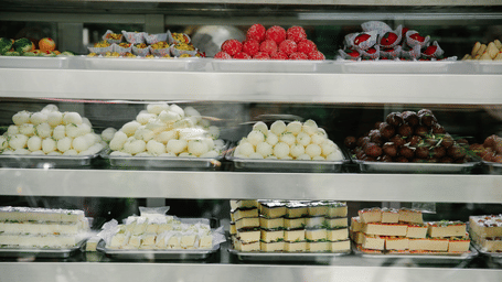 Trays full of Bengali traditional sweets displayed in a shop.