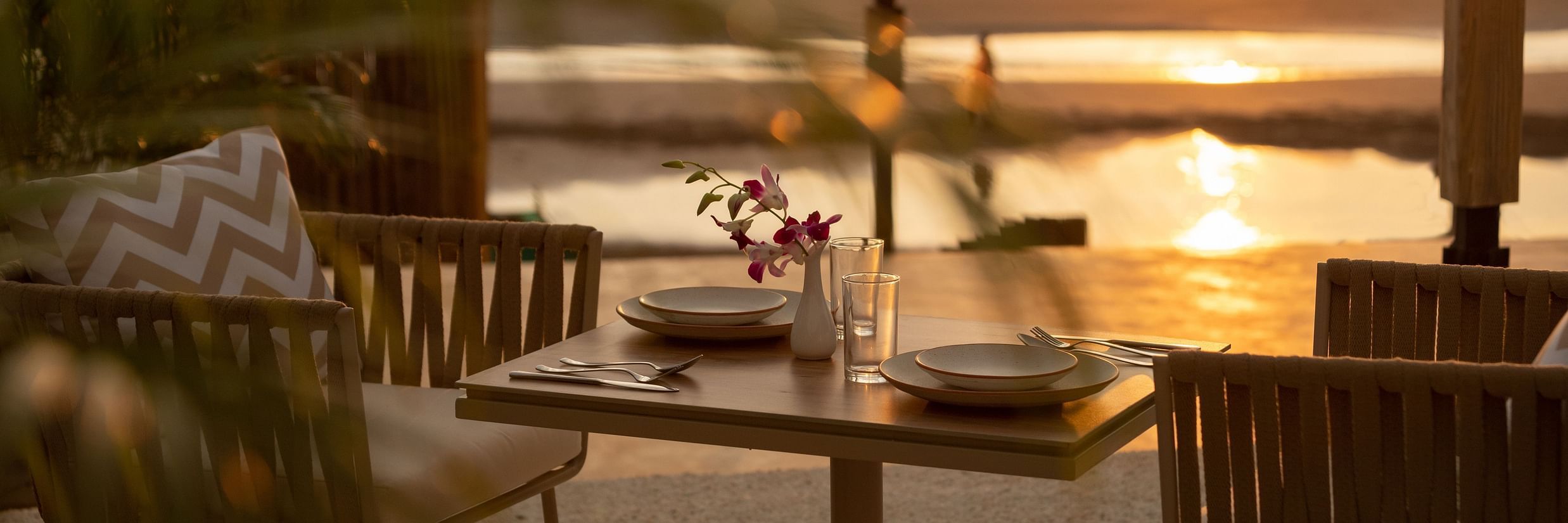 a closer view of seaside restaurants in Goa captured during sunset with gentle waves hitting the shores